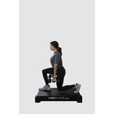 Female Model doing stretches on VibePlate 2440 Whole Body Vibration Machines with dumbells